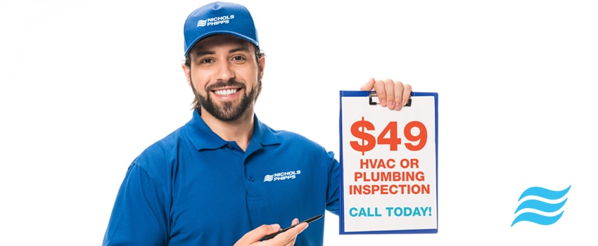 Man holding HVAC or Plumbing Inspection $49 Call Today Nichols & Phipps